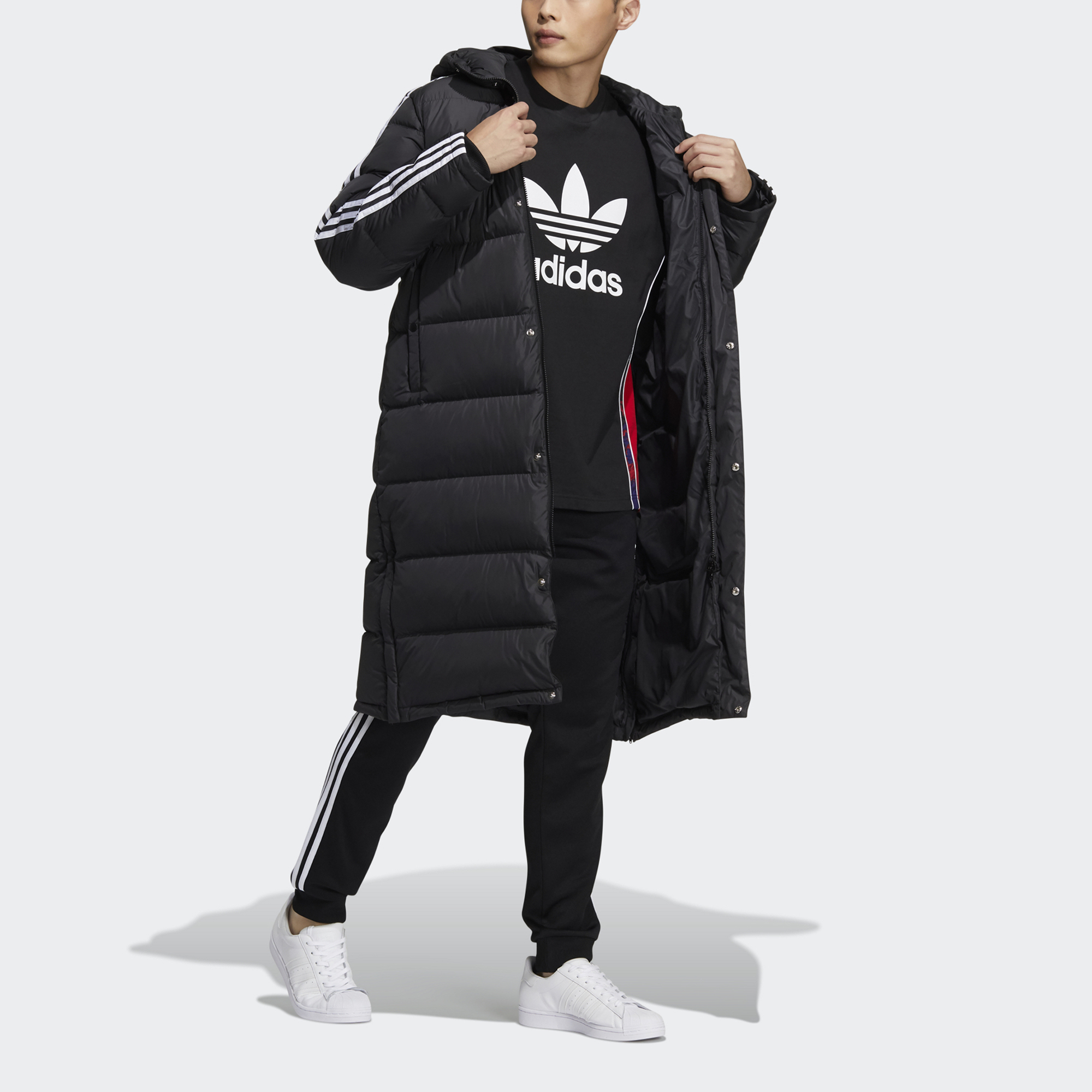 Shop adidas Originals黑色長版羽絨外套側邊三條紋冬季設計 HI4658