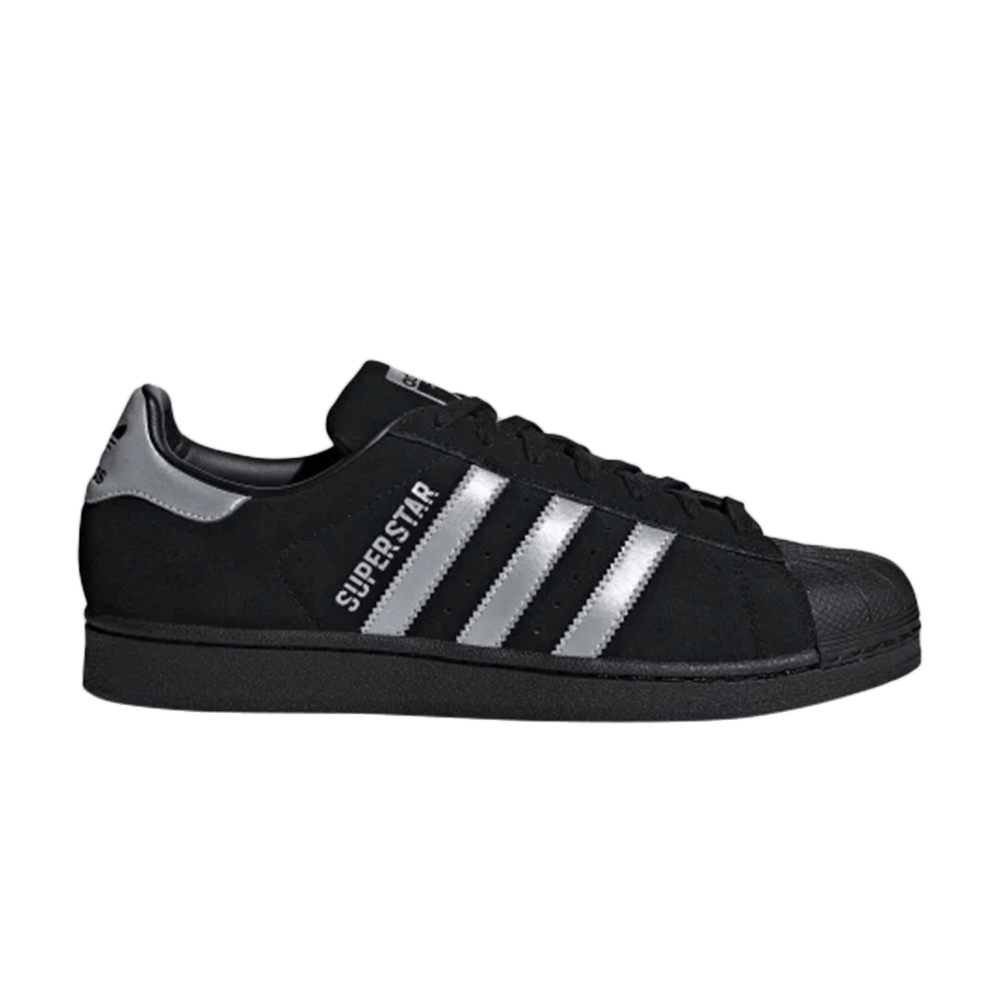 black adidas with silver stripes