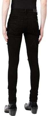 Vaqueros de mezclilla negros con logo desgastado en las rodillas AMIRI SS23. PS23MDS006-018 Shop Vaqueros de mezclilla negros con logo desgastado en las rodillas AMIRI SS23. PS23MDS006-018