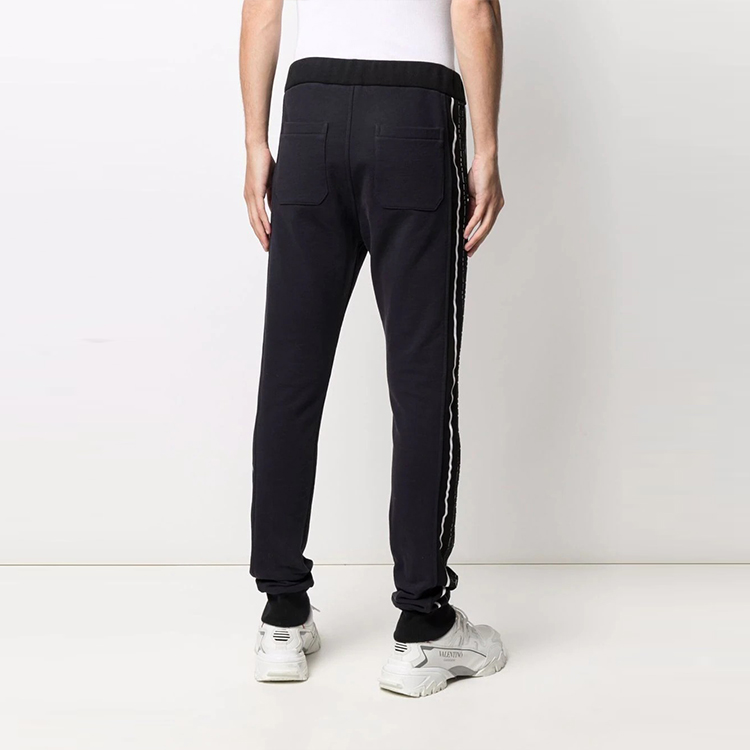 Shop BALMAIN FW21 Knit Joggers with Side Logo Patch Black. WH1OB021-273J-SDO