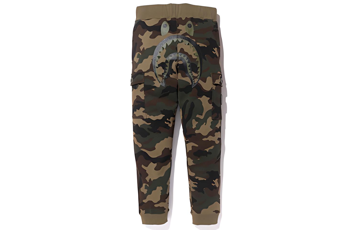 BAPE x UNDEFEATED Woodland Camo Shark Slim Pants Unisex Camo Sweatpants. 1D73-152-922