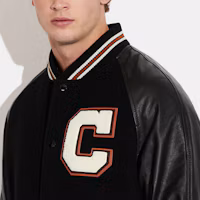 Purchase COACH SS23 Black Baseball Jacket with Logo Patch and Button Closure. CF802-BLK