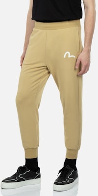 EVISU 太鼓達磨プリントジョガースウェットパンツ ベージュ 2ESHTM3SP315XXCT Shop EVISU 太鼓達磨プリントジョガースウェットパンツ ベージュ 2ESHTM3SP315XXCT