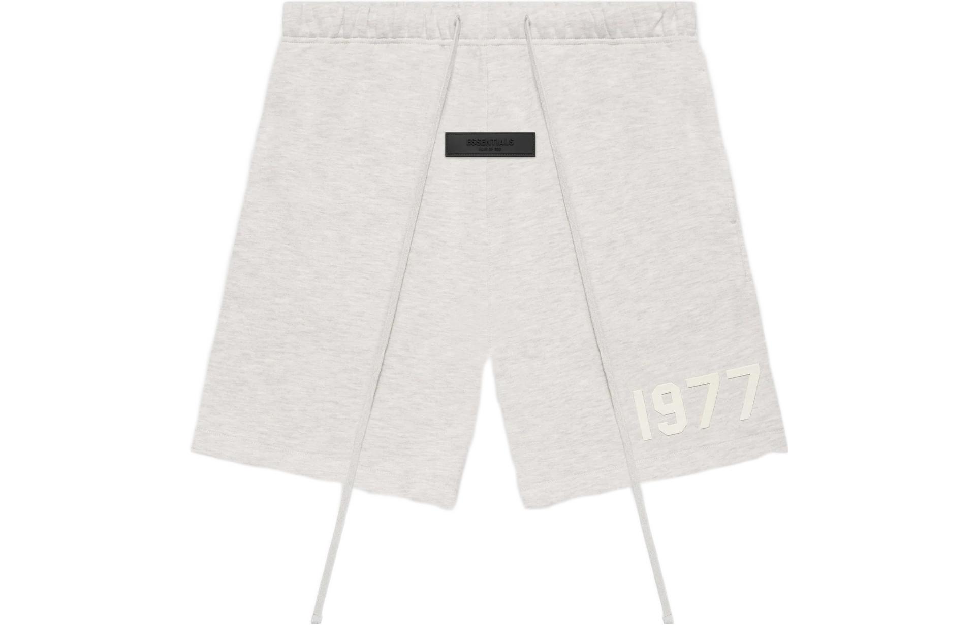 Fear of God Essentials 1977 SS22 Light Oatmeal Flocked Logo Sweat Shorts. FOG-SS22-094