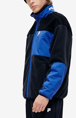 FILA FUSION Faux Shearling Logo Warm Jacket in Black. T11M241903F-BK Sizing FILA FUSION Faux Shearling Logo Warm Jacket in Black. T11M241903F-BK