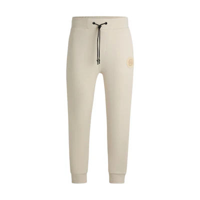 HUGO BOSS Beige Knit Joggers with Logo Patch and Lace-Up Design. 50521382-131