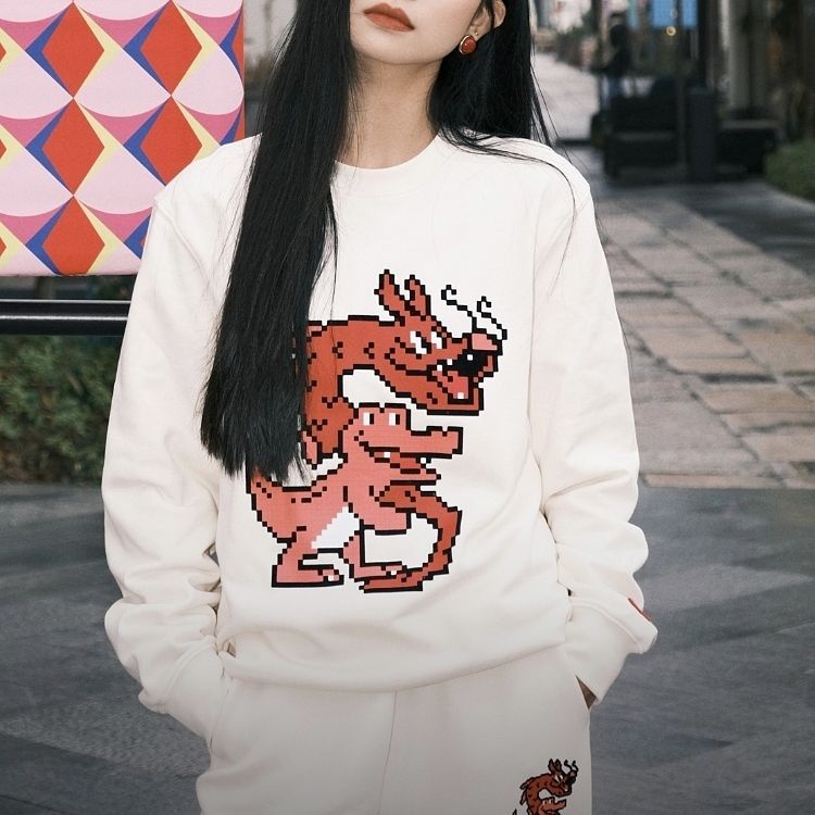 Shop Lacoste Lunar New Year Cartoon Print Cream White Unisex Sweatshirt SH4755-XFJ