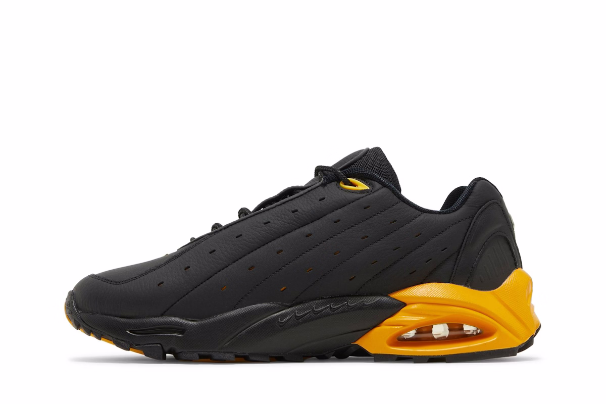 NOCTA x Nike Hot Step Air Terra 'Black University Gold'