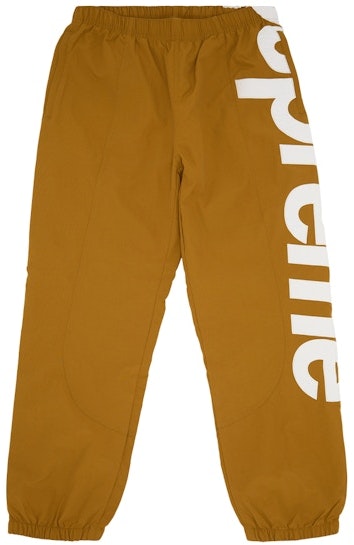 supreme-spellout-track-pant-dark-gold