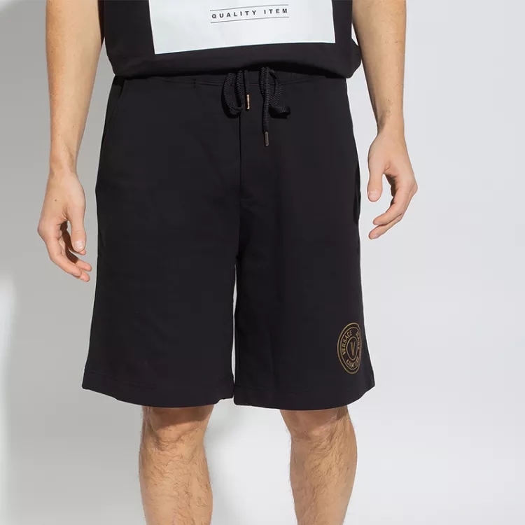Lookbook Versace Jeans Couture SS22 Black Casual Pants with V-Emblem for Men. 72GADT03-72UP327-G89